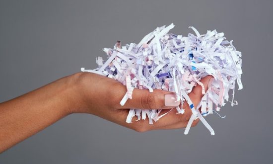protect-your-information-studio-shot-womans-hand-holding-pile-shredded-paper-against-grey-background_590464-40048